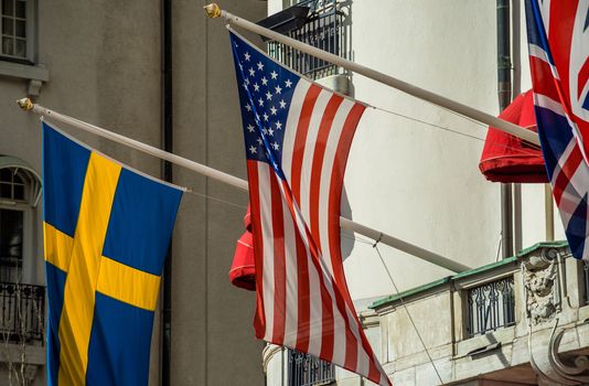 Flags of Great Britain, USA and Sweden on the facade of the hotel