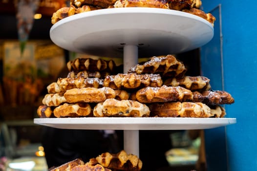 Viennese waffles on a tray on a shop window of a pastry shop.