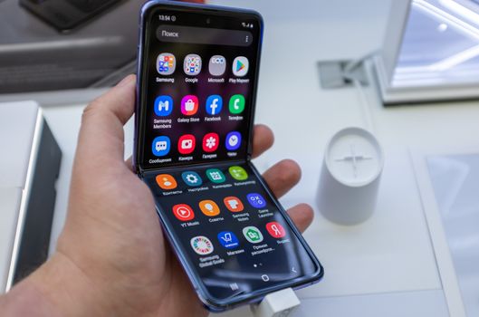 February 22, 2020, Moscow, Russia. New folding smartphone with a folding screen Samsung Galaxy Z Flip on the store counter.