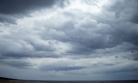 Clouds on a cloudy sky over the sandy beach of the Baltic Sea in Jurmala