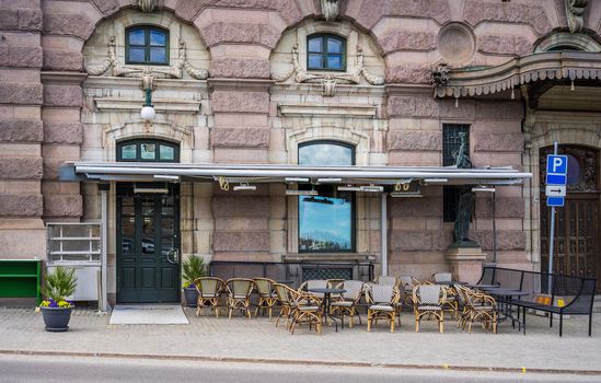 April 22, 2018. Stockholm, Sweden.  Tables of a summer cafe on a street in the center of Stockholm.