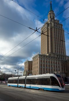 April 1, 2019 Moscow, Russia. Tram on the background of the building of the Leningradskaya hotel on the square of Three stations in Moscow.