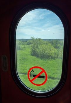 Sign "Smoking is prohibited" on the window of the vestibule of a long-distance train