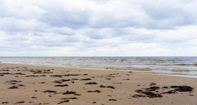 Clouds on a cloudy sky over the sandy beach of the Baltic Sea in Jurmala