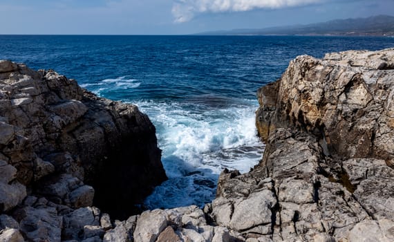 Waves crash on the rocky shore of the Mediterranean Sea on the Akamas Peninsula in the northwest of the island of Cyprus.