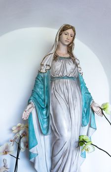 Statue of holy woman isolated on light background