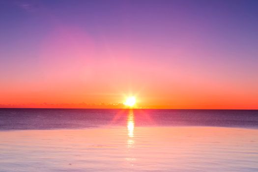 Sunset over the sea. Full calm at sea at sunset.