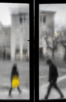 People out of the old window. Blurred aged photo. Faded colors.