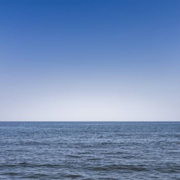 Front view of the sea with blue sky in the background.