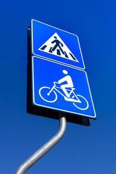 Road sign warns about pedestrian crossing and bicycle road