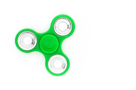 Green finger spinner (stress anxiety relief toy) isolated on white background. Overhead view.