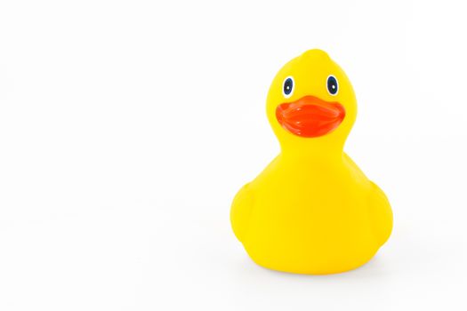 Cute yellow rubber duck isolated over white background
