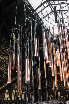Large wind chimes with contemporary design, installed in an exhibition hall.