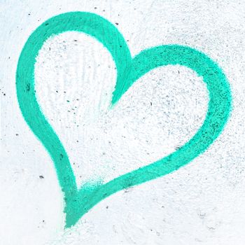 Concept or conceptual painted turquoise abstract heart shape love symbol, dirty wall background, metaphor to urban and romantic valentine, grungy style.