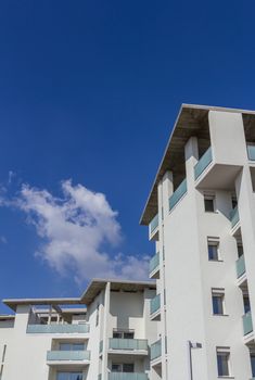 White living house with appartments and balconies with sky background