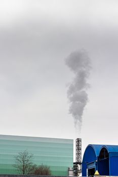 Pollution of a factory with smog and chimney smoke