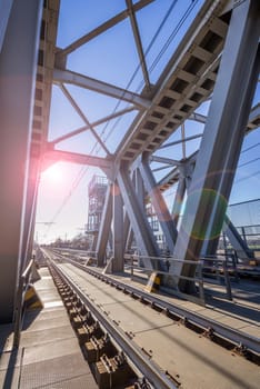 Modern railway steel bridge over highway