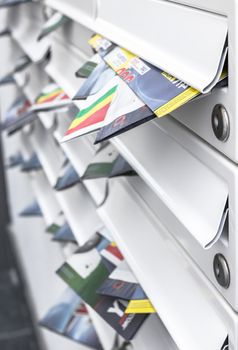 Modern mailboxes filled of leaflets. Business and advertising concepts. Shallow depth of field.