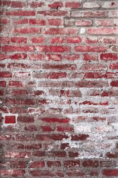 Details of the surface of an old wall in stones red and gray.