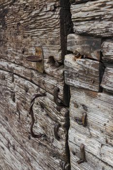 Details of iron and rust on an old wooden door