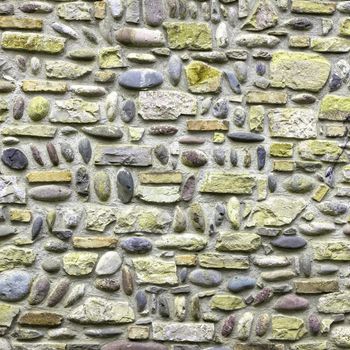 Pattern of green and violet stone wall surfaced.