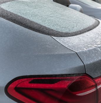 Frozen car during winter day