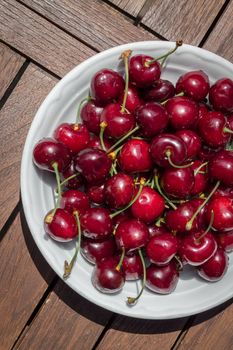 Ripe fresh rich cherries in the plate. Fruit background. Shallow DOF.