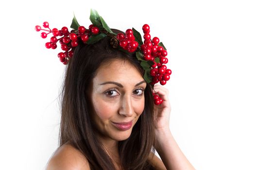Christmas or New Year beauty woman portrait isolated on white background. Smiling young woman with wearing a Christmas wreath on her head. Natural makeup.