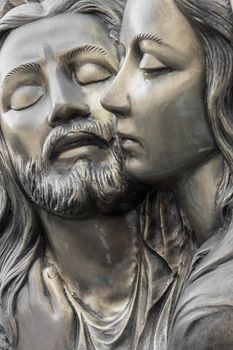 Bas-relief in bronze representing The Pity of Michelangelo. Faces of Holy Mary mother and Jesus Christ after the Crucifixion.