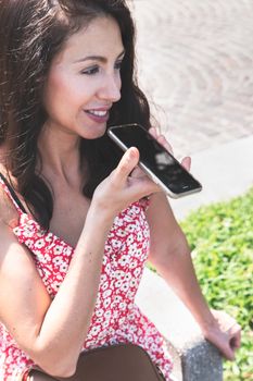 Attractive young woman talking on mobile phone. Leisure, technology, communication and people concept.
