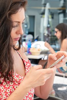 Attractive young woman using mobile phone. Leisure, technology, Social Network, communication and people concept.