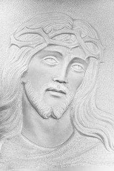 Stone white Bas-relief of the face of Christ with a crown of thorns. Ideal for concepts and backgrounds
