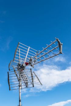 Directional antenna for reception of digital television broadcasting DVB-T and DVB-T2 against a blue sky.