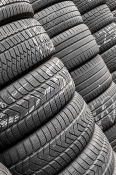 Close up stacks of old used tires for sale