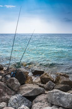 Two fishing rods on the cliff. Sport and recreation concept. No people.