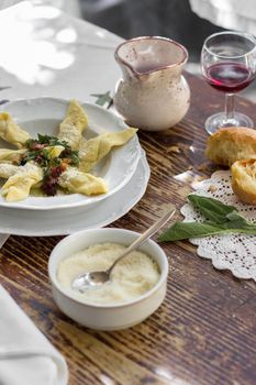 Typical italian cuisine. Casoncelli alla bergamasca (pasta stuffed with bread crumbs, egg, parmesan, ground beef, salami) on white plate in local restaurant in Bergamo, Lombardy.