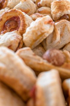 Mix of delicious appetizers. Small pizzas made of puff pastry. Selective focus