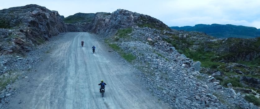 Motorcyclists go on a mountain road. Mountain landscape.