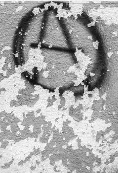 Symbol of anarchy painted on the peeling old wall. Ideal for textures ,backgrounds and concepts.