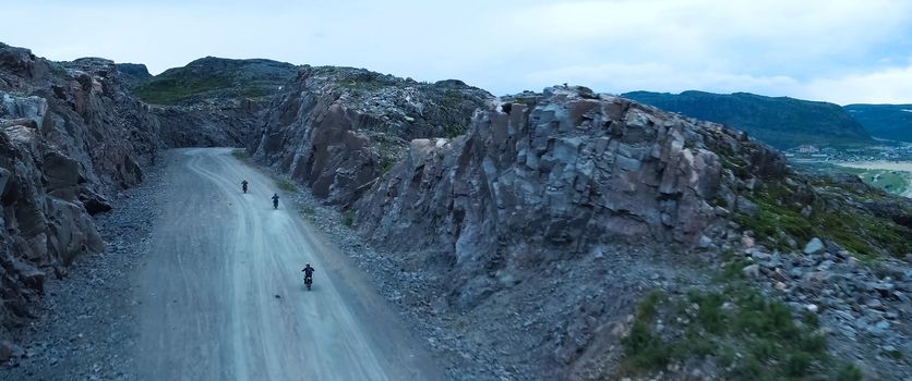 Motorcyclists go on a mountain road. Mountain landscape.