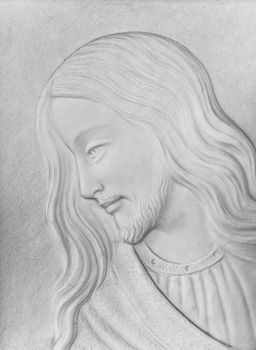 White stone Bas-relief of Christ smiling. Ideal for concepts and backgrounds.