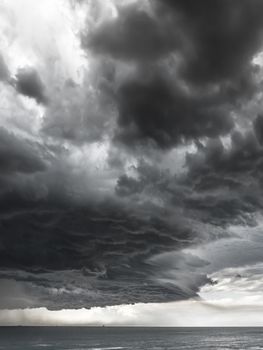 Dramatic seascape with dark stormy clouds. Thunderstorm.