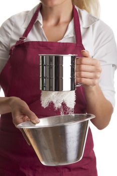 woman in an apron with a sieve