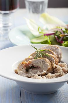 slices of stuffed chicken breast on risotto