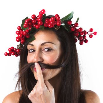 Christmas or New Year beauty woman portrait isolated on white background. Smiling young woman with wearing a Christmas wreath on her head, playing with her hair. Natural makeup.