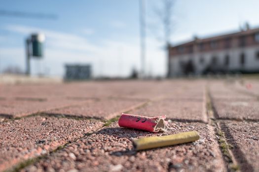 Old firecrackers exploded on the ground. Selected focus.