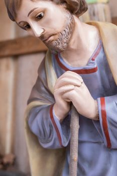 St. Joseph wooden statue in a traditional Italian Christmas crib. Close up.