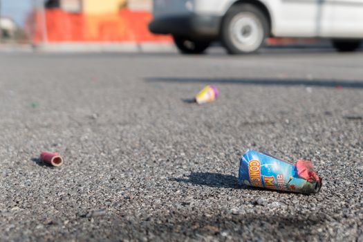 Old firecrackers exploded on the ground. Selected focus.