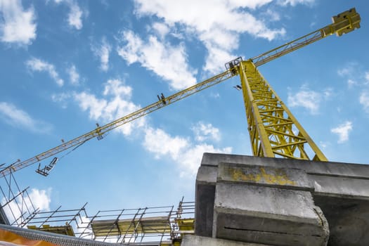 Extensive scaffolding providing platforms for work in progress on a new apartment block. Construction site. Housing crane operation. High rise Building Under Construction.