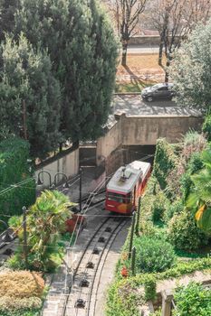 Upper city funicular line in Bergamo (Funicolare Citta Alta). Red funicular connects old Upper City and new. Scenic view of Bergamo historical center. Bergamo (upper town), ITALY - October 5, 2019